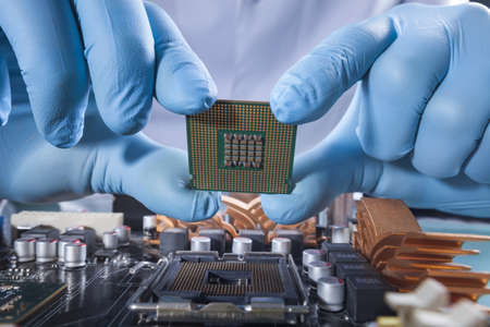The scientist holds the computer part
