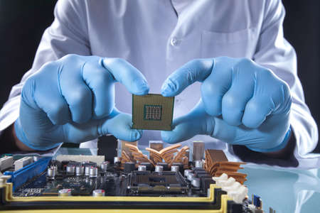 The scientist holds the computer partの写真素材