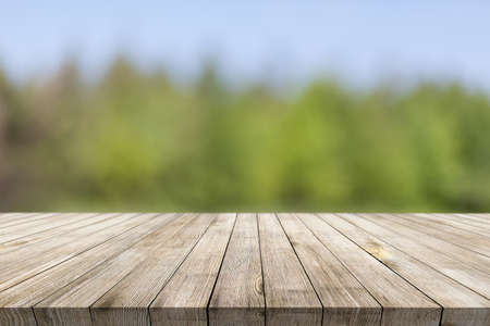 Wooden desk on natural bokeh backgroundの写真素材