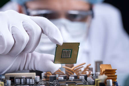The scientist holds the computer partの写真素材