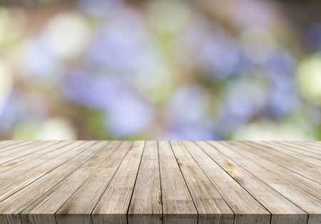 Wooden desk on blur or abstract natural backgroundの写真素材