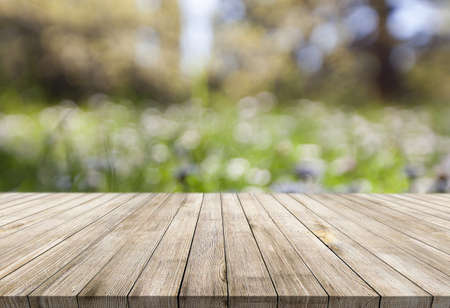 Wooden desk on blur or abstract natural backgroundの写真素材