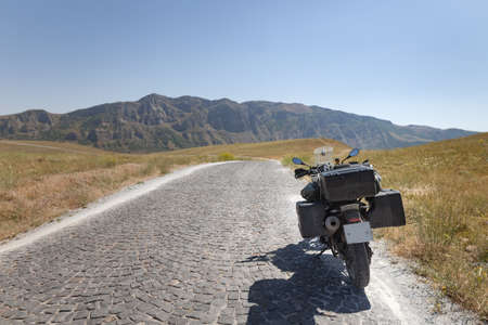 Beauty motobike on lanscape long road and fieldの写真素材
