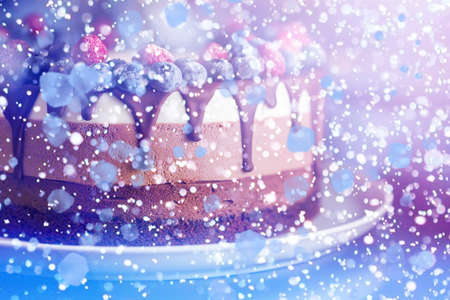 Beautiful fresh berry chocolate cake with abstract illustration on white plateの写真素材