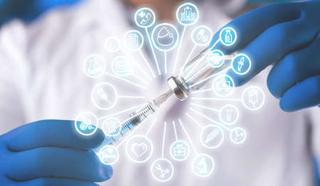 Doctor man in a white coat with a stethoscope on an abstract blur bokeh backgroundの写真素材