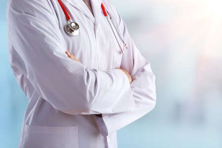 Young doctor with a stethoscope shows stop sign with his handsの写真素材