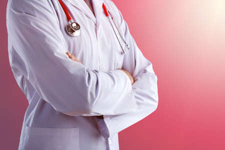 Young doctor with a stethoscope shows stop sign with his handsの写真素材