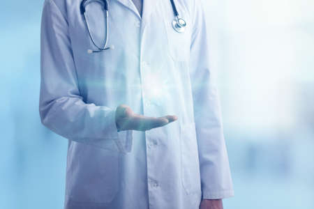 Young doctor with a stethoscope shows with his handsの写真素材