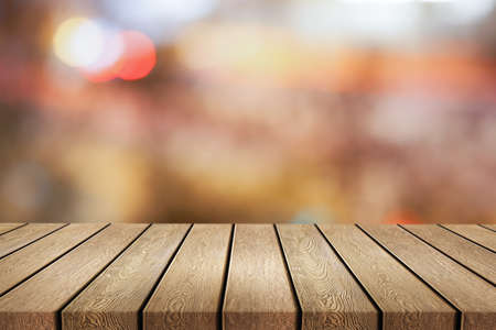 Wooden desk on bokeh blur abstract light backgroundの写真素材