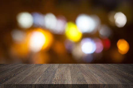 Wooden desk on bokeh blur abstract light backgroundの写真素材