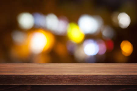 Wooden desk on bokeh blur abstract light backgroundの写真素材