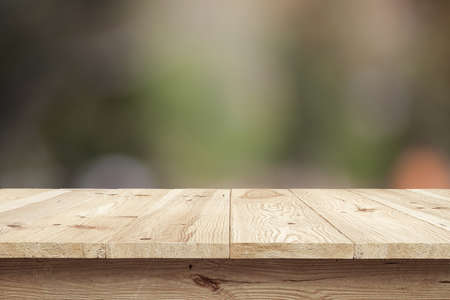 Wooden desk on bokeh blur abstract natural backgroundの写真素材