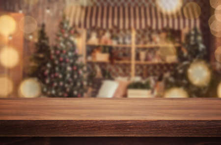 Wooden desk on bokeh blur abstract christmas backgroundの写真素材