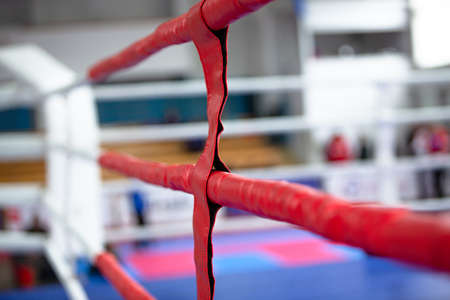 Red boxing ring ropes on blurred bokeh sports backgroundの写真素材