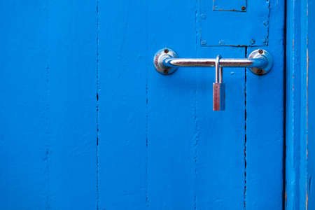 Blue pastel beautiful interior door with metal lock, close concept