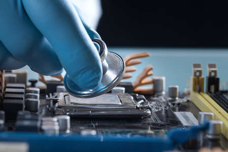 Scientist working with a computer motherboard, technology conceptの写真素材