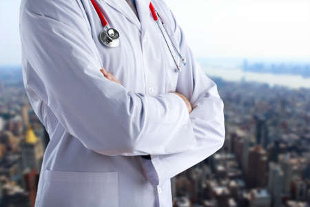 Young doctor with a stethoscope shows stop. Concept sign with his handsの写真素材