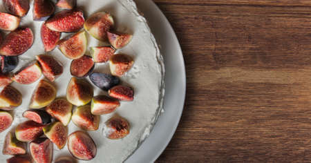 Homemade cheesecake with fresh berries and lavander for dessert on deskの写真素材