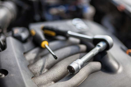 Man master repairs under the hood of the car. Repairing conceptの写真素材