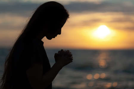 Silhouettes of women with the sun at sunset