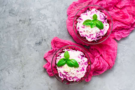 Traditional Russian salad - herring under a fur coat in bowls on the table. Top viewの写真素材