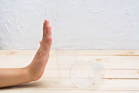 Hand shows rejection of disposable plastic cups. Zero Waste Conceptの写真素材