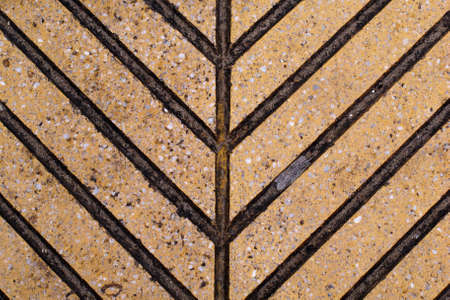 Brown tile with dark blotches forming arrowsの写真素材