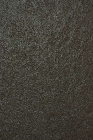 Dark, gray stone with rough texture visible.の写真素材