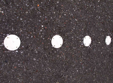 Wall of small stones with four white circlesの写真素材