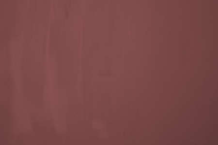 Wall in red with noticeable brush marks and different shadows の写真素材