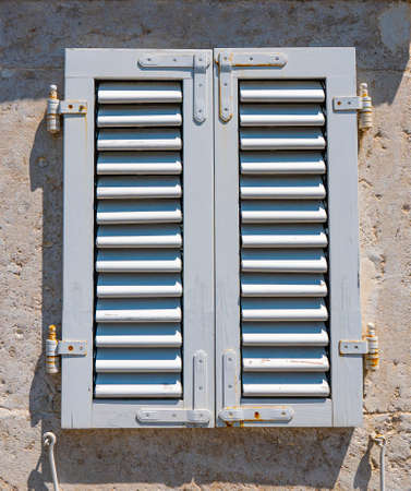 building's facade. Wall of an old house. Closed wooden window. architectural detail. close-upの写真素材