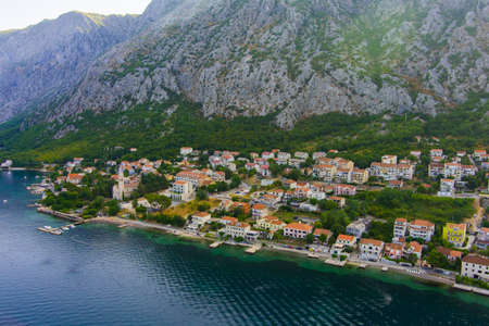 Montenegro. Adriatic Sea. Bay of Kotor. popular tourist spot. Village on the coast. Houses with orange tiled roofs. Summer. tourist season. drone. Aerial viewの写真素材