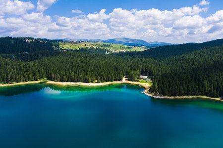 Montenegro. Zabljak. Durmitor National Park. popular tourist spot. Black lake surrounded by green coniferous forest. Beauty of nature concept background. drone. Aerial viewの写真素材
