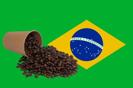 Coffee beans spilled out of paper cup and flag of Brazilの写真素材