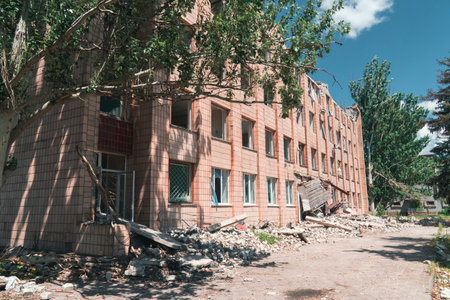 Administrative building damaged by shelling. War in Ukraine. Russian invasion of Ukraine. Destruction of infrastructure. Terror of the civilian population. war crimesの写真素材