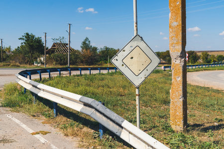 Road sign with bullet holes in a war zone. War in Ukraineの写真素材