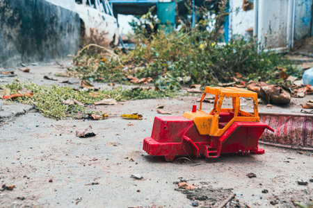 Countryside. Children's toy lies in the yard in front of the house, destroyed by shelling