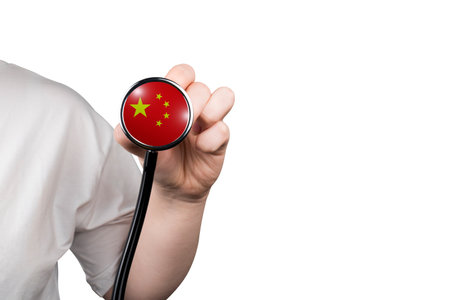 Doctor holding a stethoscope with China flag, isolated on whiteの写真素材