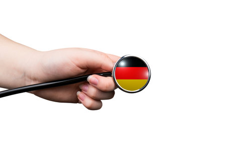 Hand with stethoscope and Germany flag, isolated on white background.の写真素材
