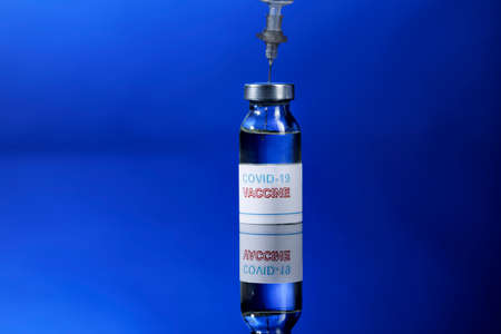Coronavirus Vaccine Bottle with Syringes, Isolated on Reflective Background