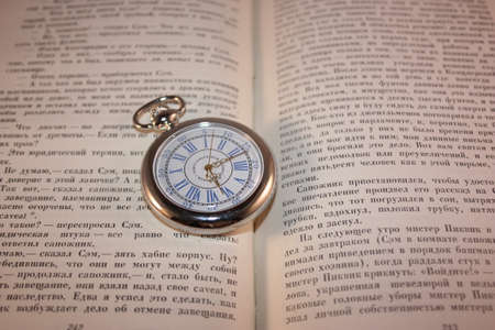 Pocket watch on the open bookのeditorial素材