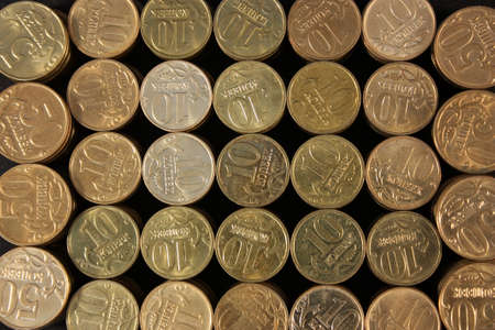 Coins stacked on a black background  