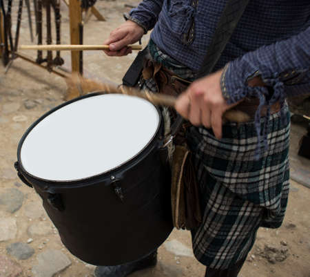 The guy holding the drumsticks in his hand. The guy playing the marching drum. Scottish drummerの写真素材
