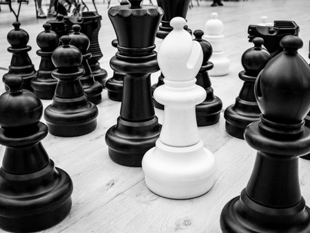 black and white chess pieces placed on a chessboard close-upの写真素材