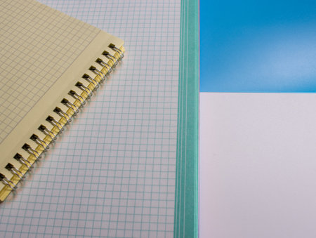 Top view of spiral notebooks on a colored surface. Flat styling style with space for text.