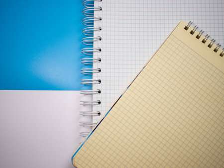 Top view of spiral notebooks on a colored surface. Flat styling style with space for text.の写真素材
