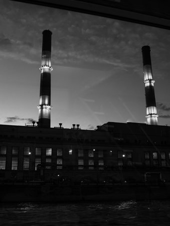 Two pipes of the city boiler house in the evening. view from the window.のeditorial素材