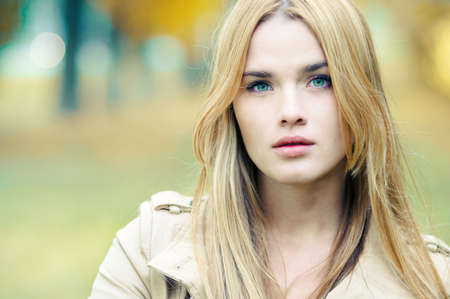Portrait of beautiful girl close up in autumnの写真素材