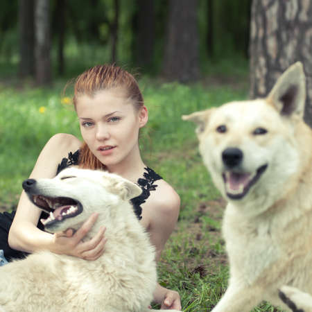 beautiful girl playing with dogの写真素材