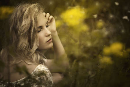 pretty girl enjoys the freshness of the fieldの写真素材